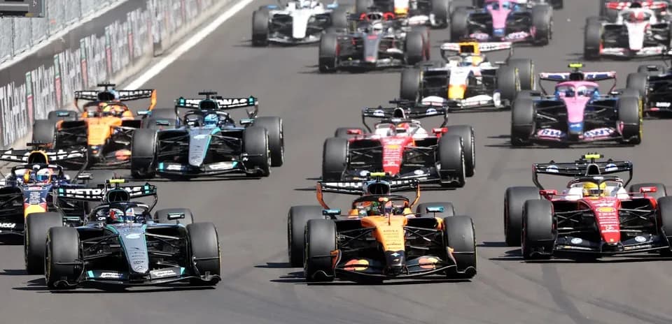 Multiple Formula 1 cars racing closely on track