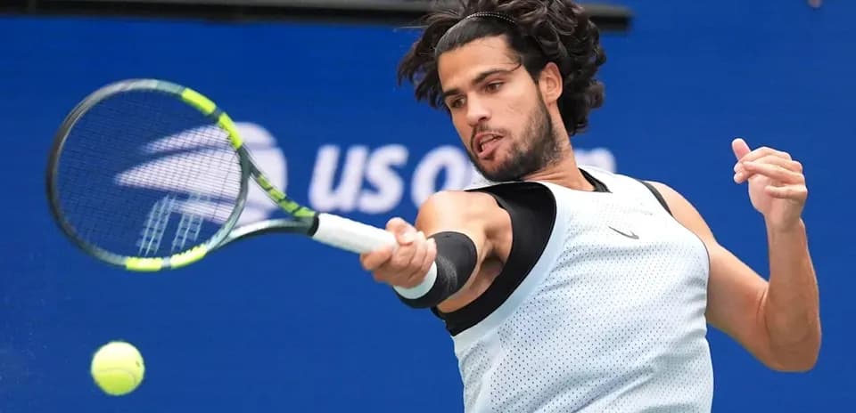 Player hitting a tennis ball during a match