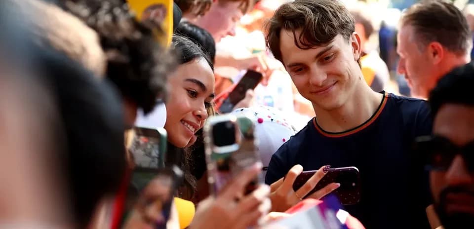 Fans taking selfies with a popular athlete