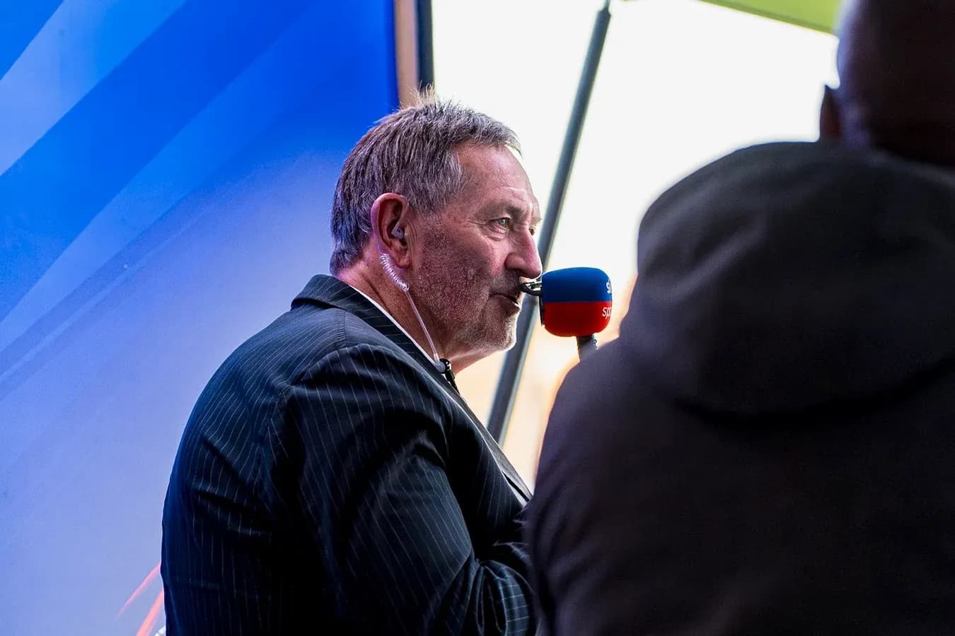 Commentator speaking into microphone during broadcast