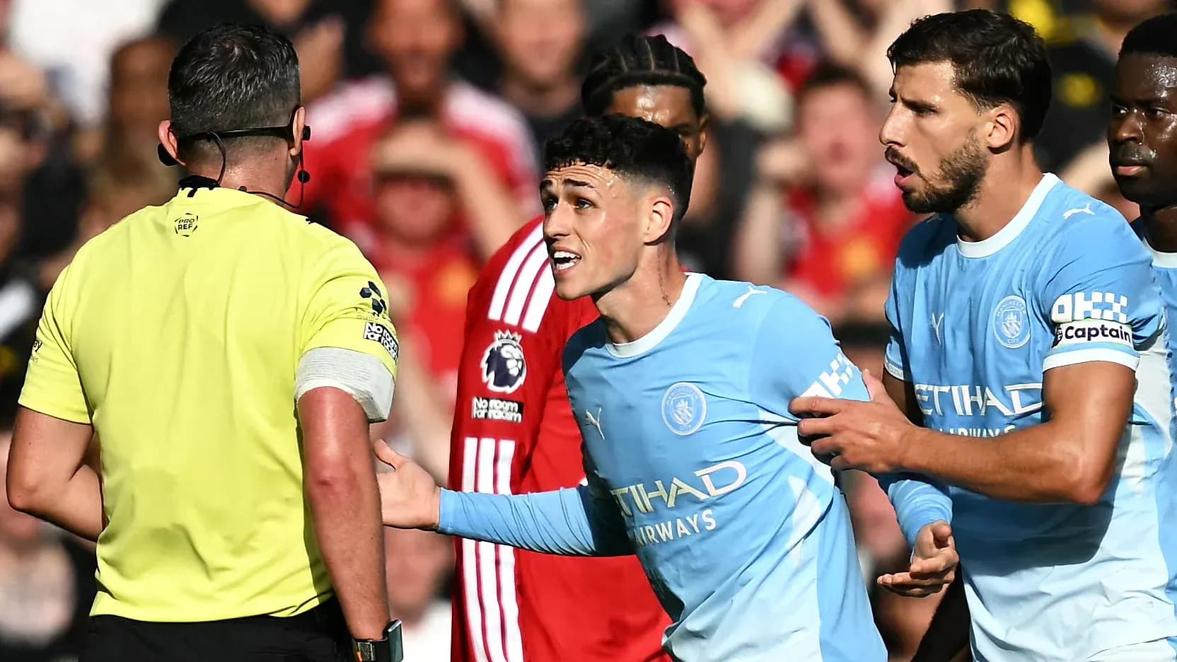 Manchester City players arguing with referee during match