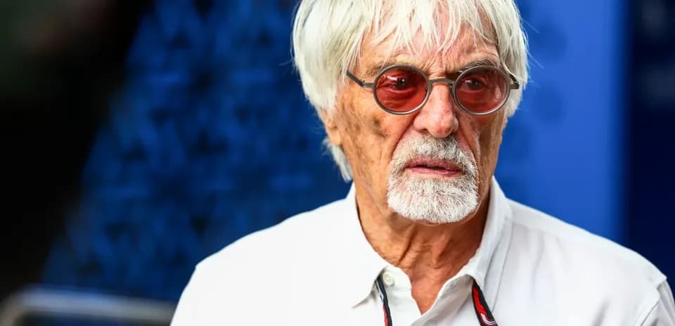 Man with white hair and sunglasses at event