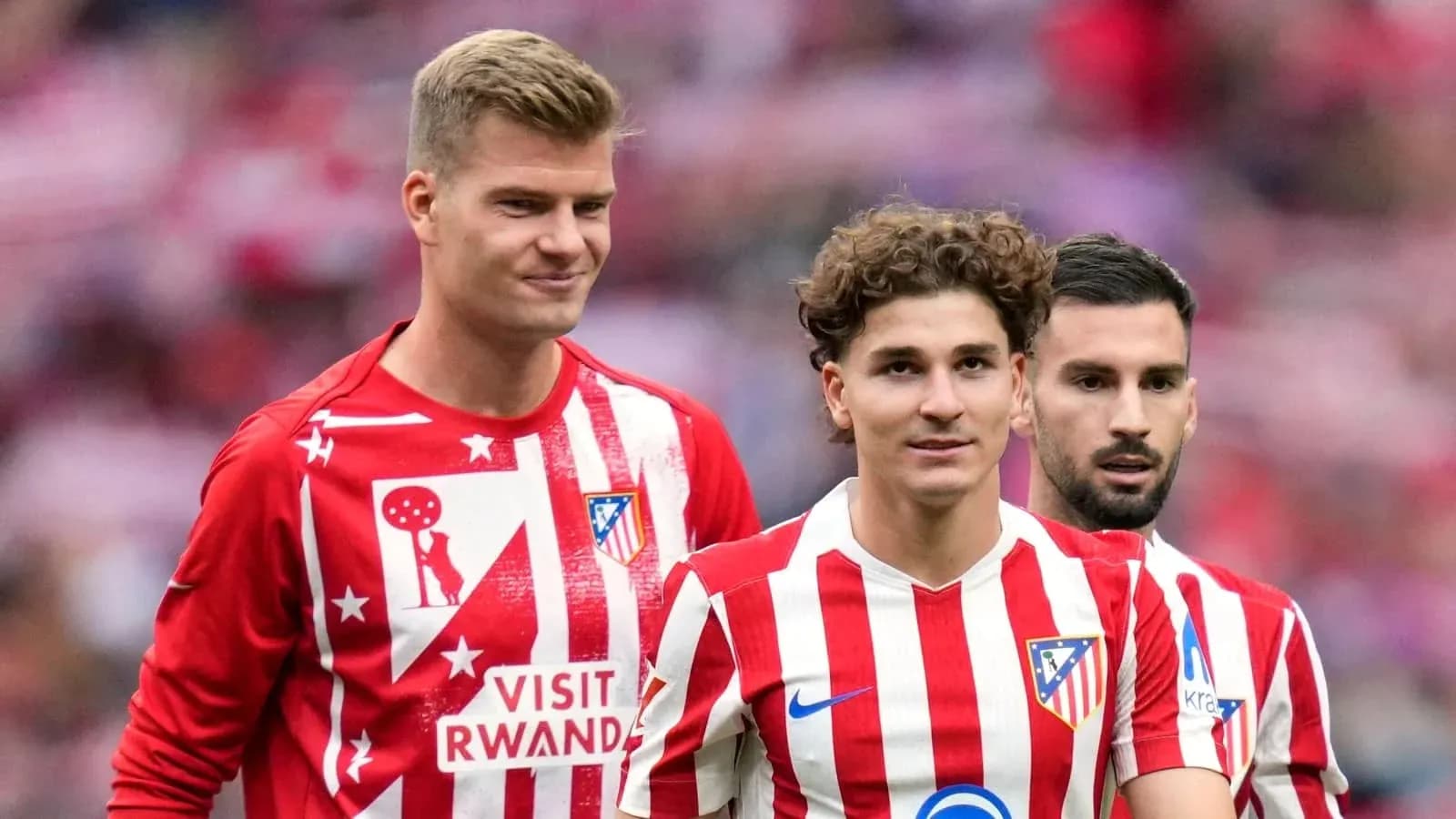 Three Atlético Madrid players in red and white kits