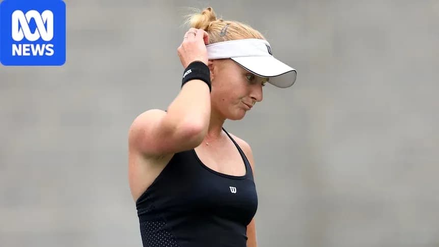 Tennis player adjusting cap during match