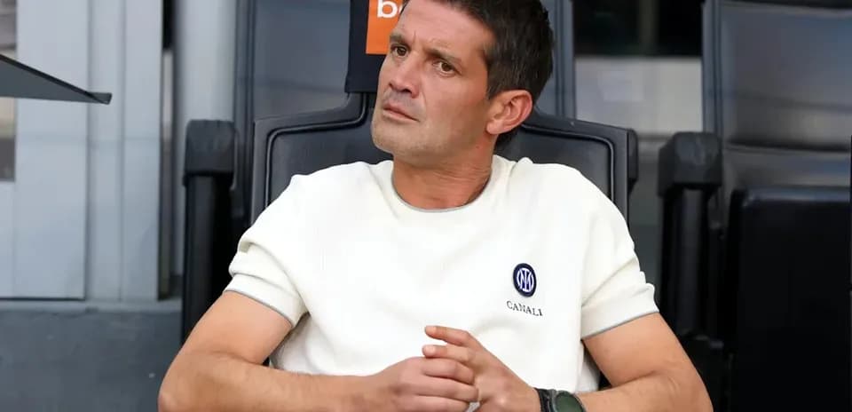 Coach seated on bench during match observation