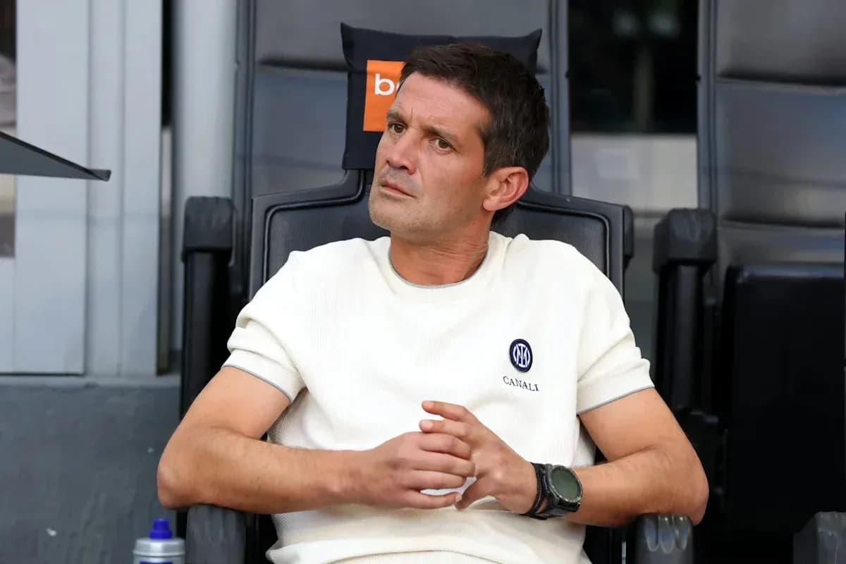 Coach seated on bench during match observation