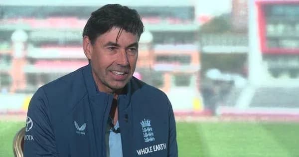 Cricket coach speaking during interview at stadium