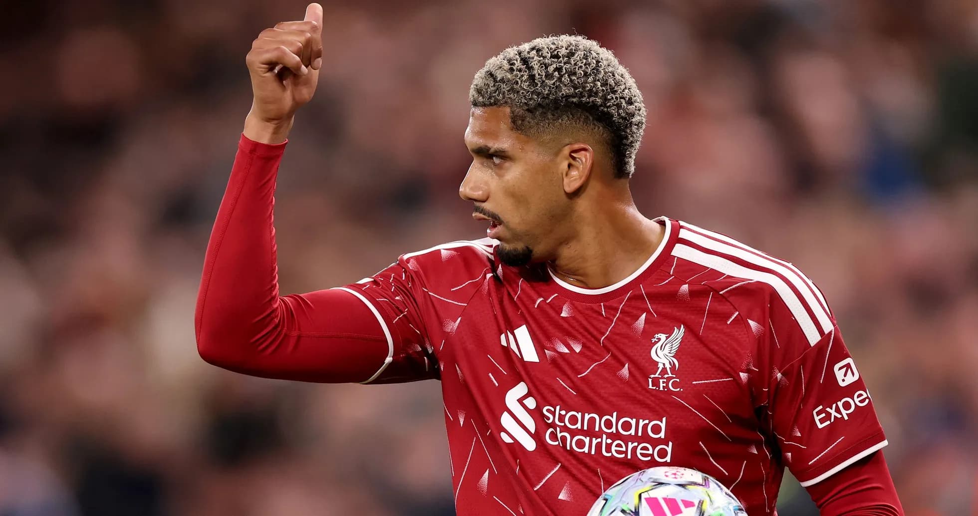 Player gesturing during match in Liverpool kit