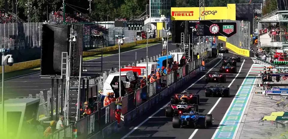 Formula 1 cars entering the pit lane during race