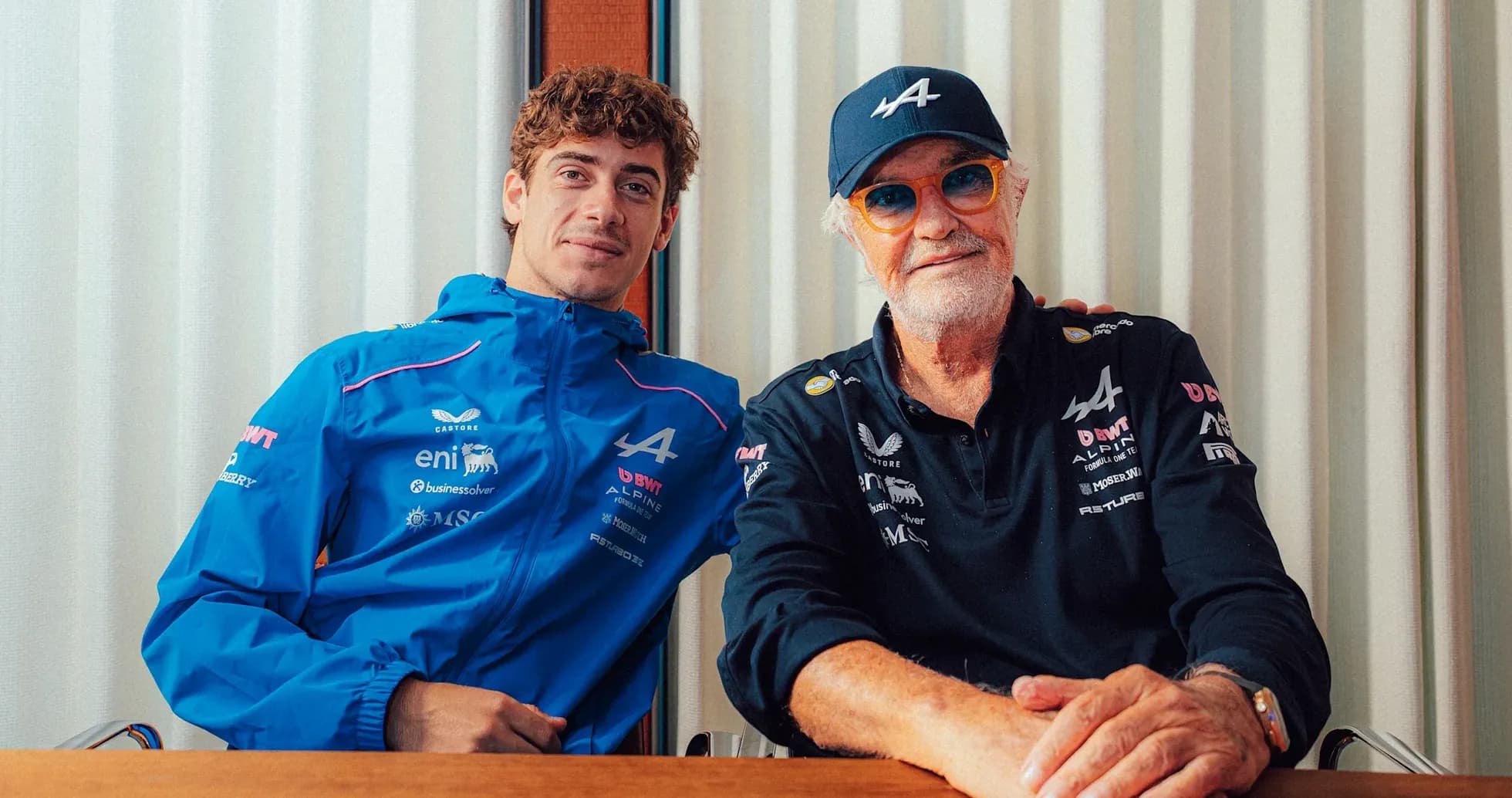 Two men posing together at a table