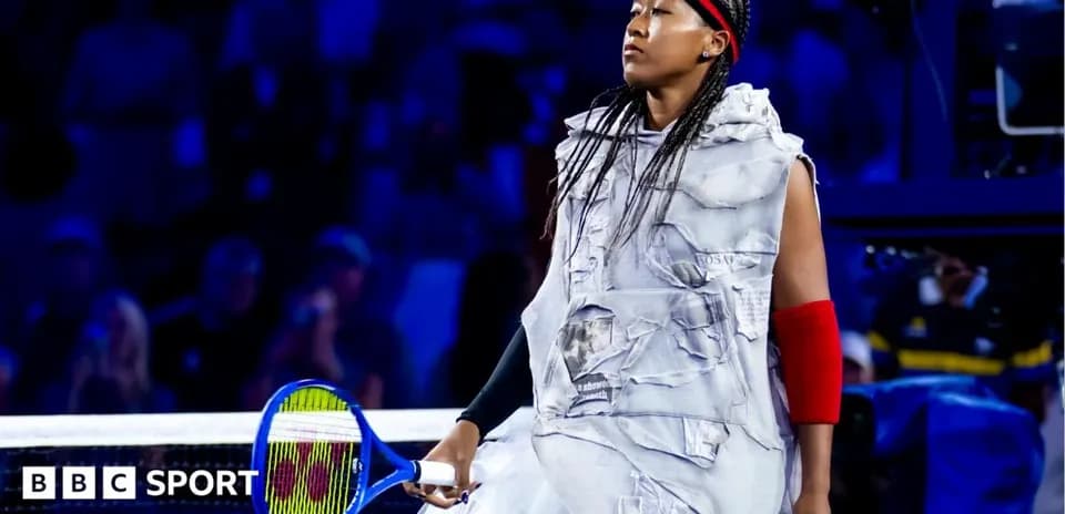 Naomi Osaka walking onto the court with racket