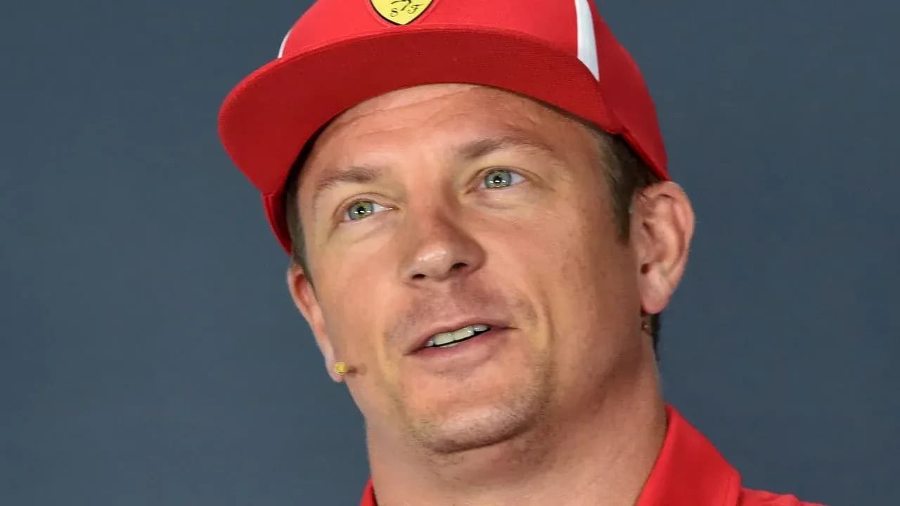 Driver speaking at press conference wearing red cap Driver speaking at press conference wearing red cap