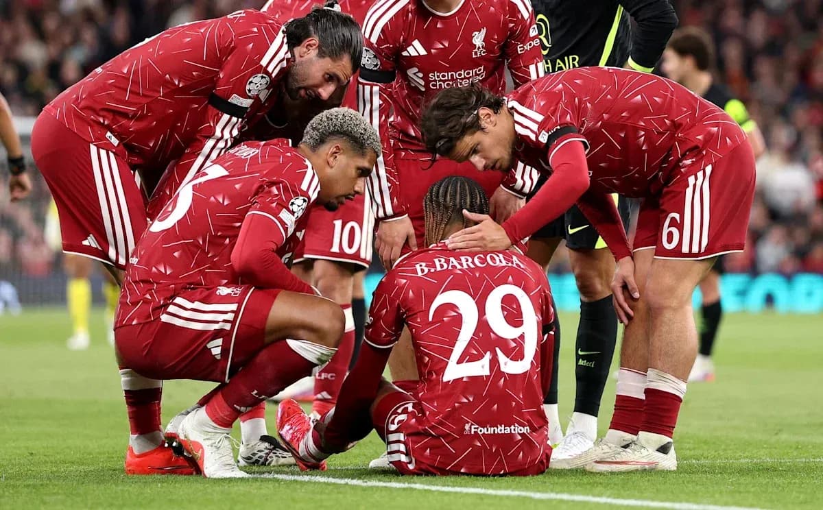 Liverpool players supporting injured teammate on pitch Liverpool players supporting injured teammate on pitch