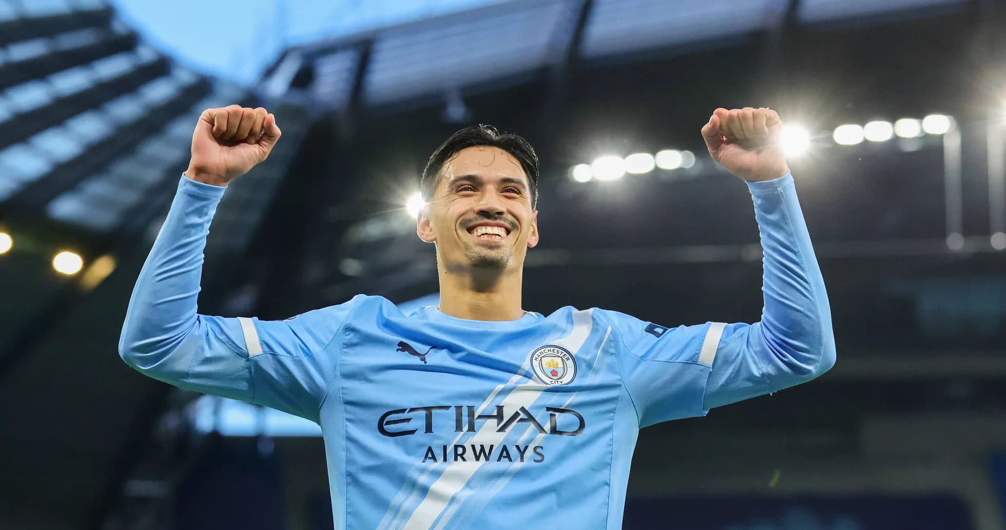Player celebrating victory at Manchester City stadium Player celebrating victory at Manchester City stadium