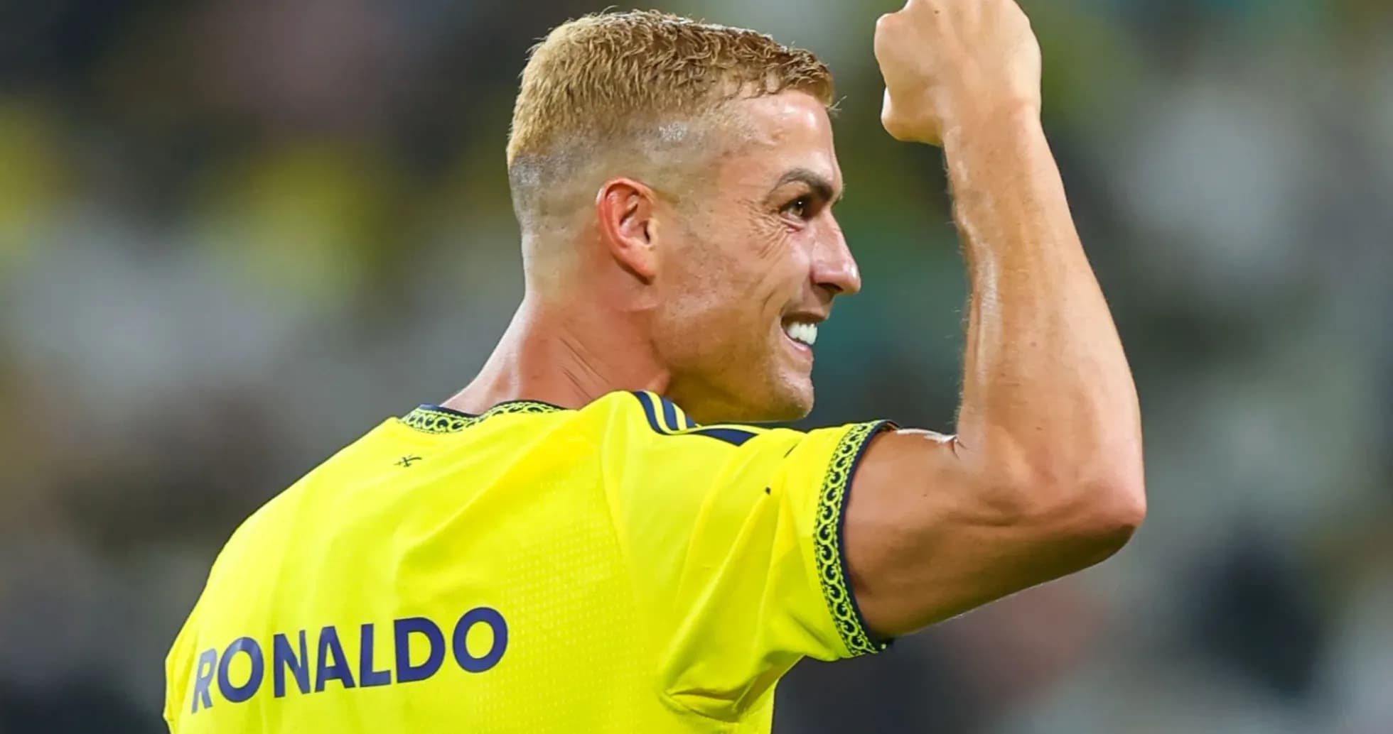 Player celebrating with raised fist on field Player celebrating with raised fist on field