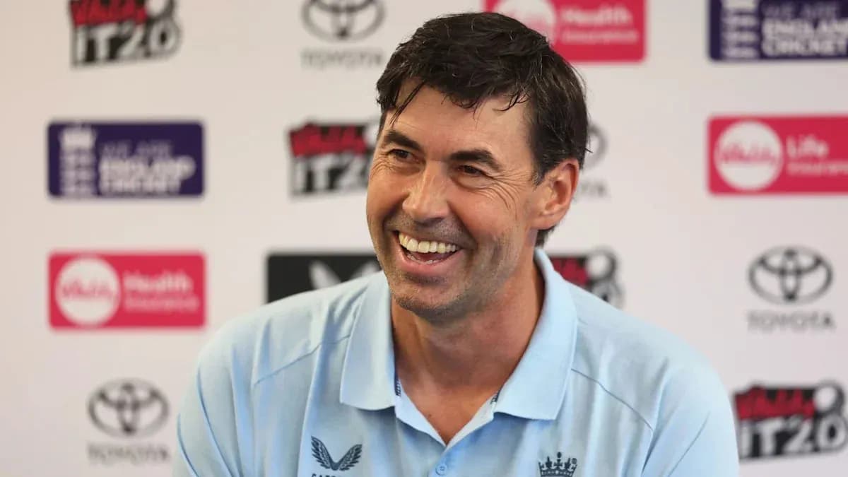 Cricket coach smiling during press conference Cricket coach smiling during press conference