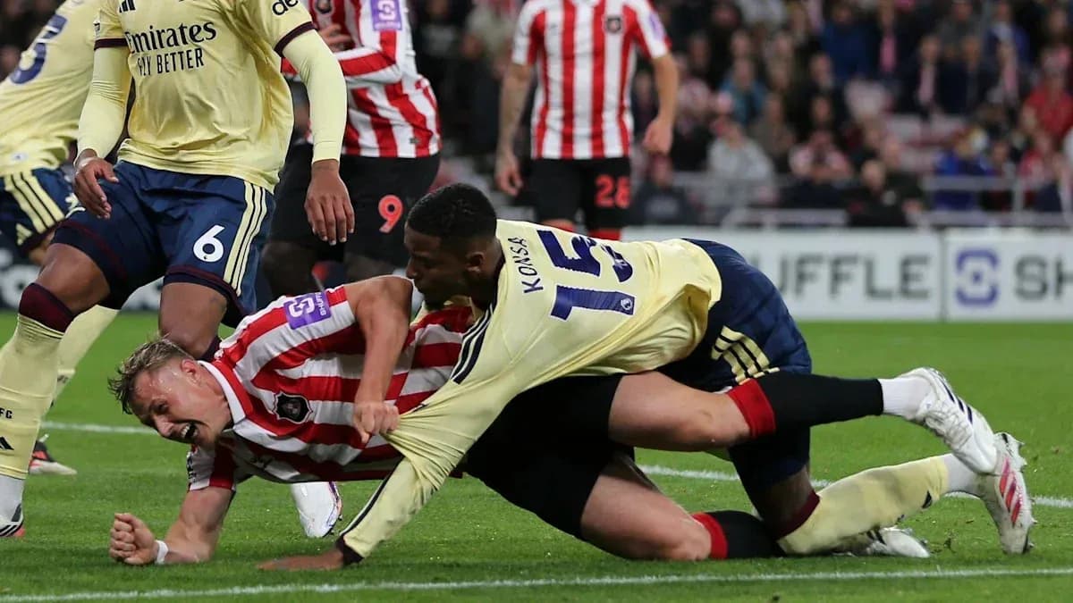 Players battling for possession on the ground Players battling for possession on the ground