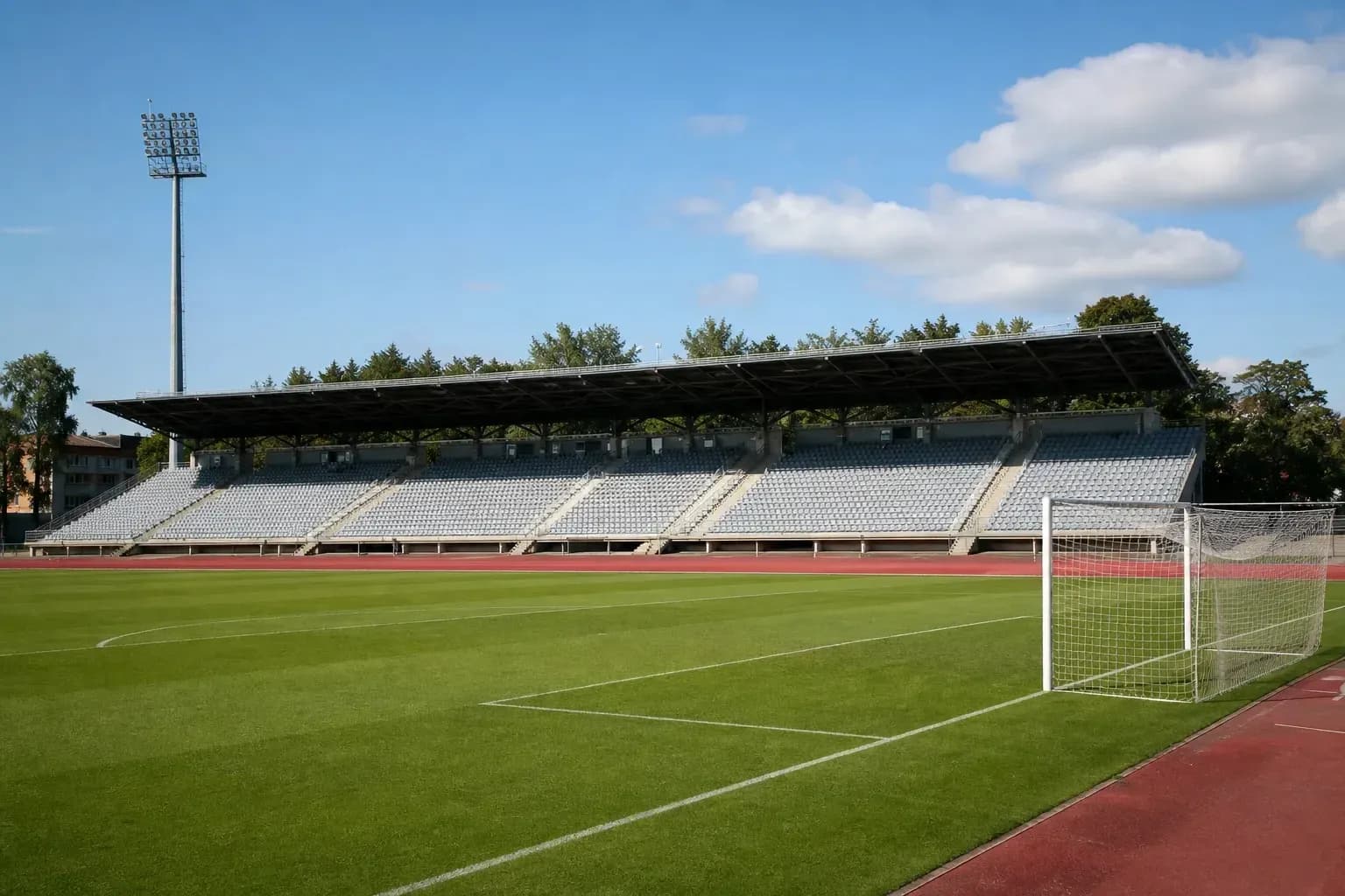 Empty football stadium with seating and goal post Empty football stadium with seating and goal post
