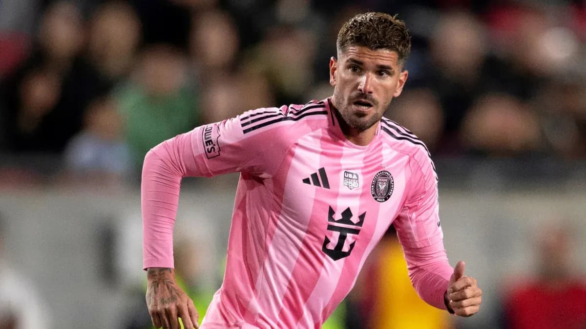 Player in pink jersey running during soccer match Player in pink jersey running during soccer match