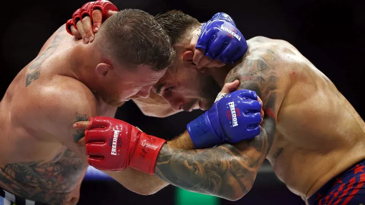 Two fighters clinching during a mixed martial arts match Two fighters clinching during a mixed martial arts match