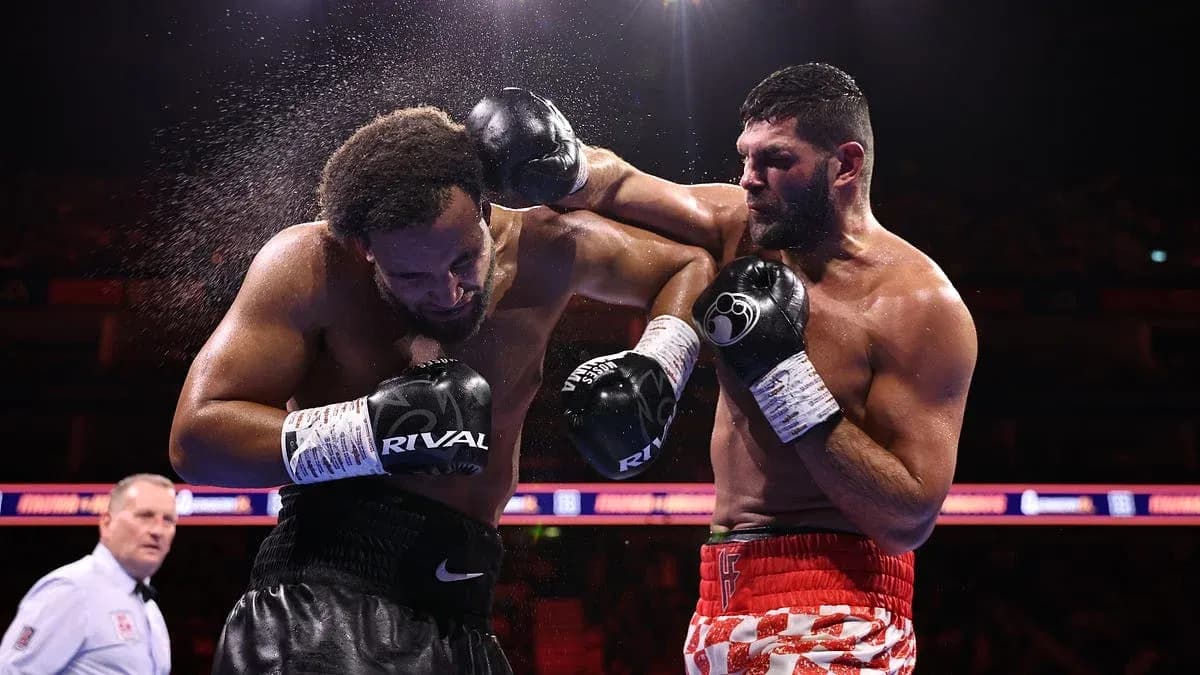 Boxers exchanging punches in a boxing ring Boxers exchanging punches in a boxing ring