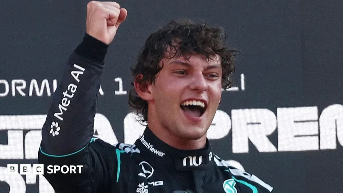 Driver celebrating victory on podium after race Driver celebrating victory on podium after race
