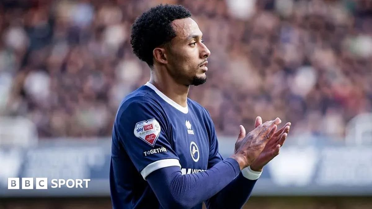 Player applauding fans during a football match Player applauding fans during a football match