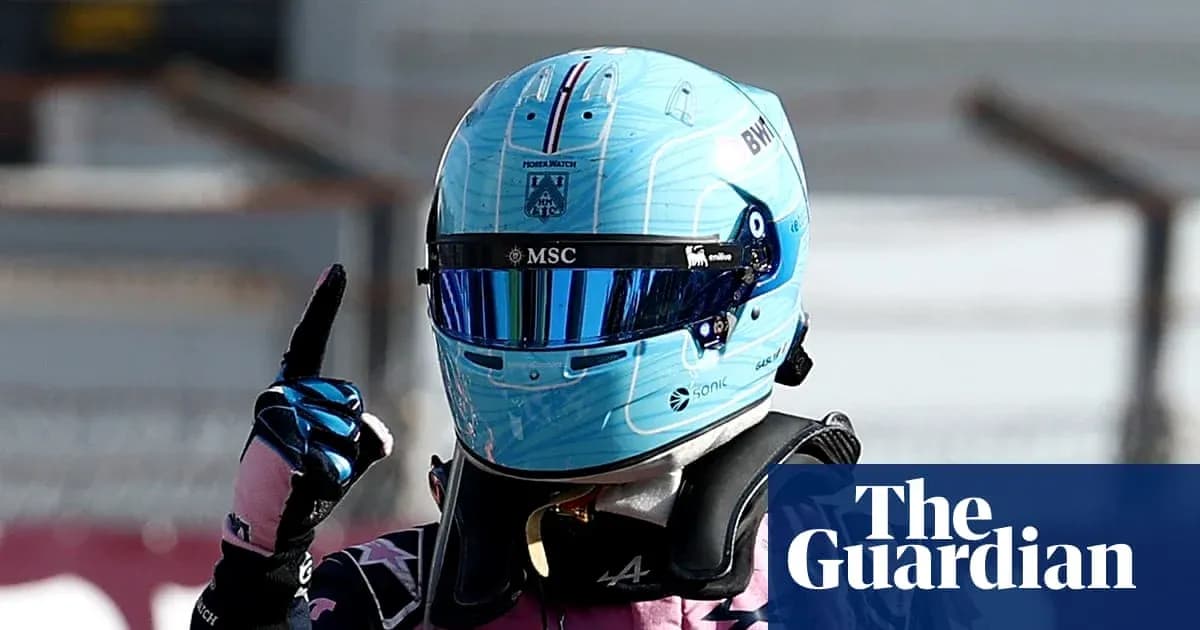 Racing driver celebrating with finger raised after race Racing driver celebrating with finger raised after race