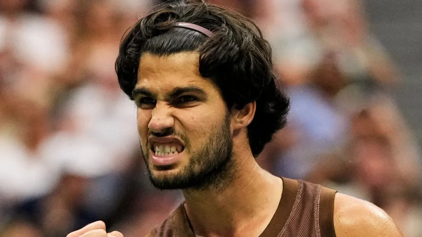 Tennis player celebrating during a match Tennis player celebrating during a match