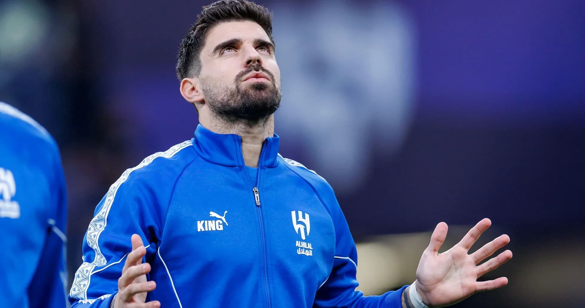Player in blue tracksuit looking up before match Player in blue tracksuit looking up before match