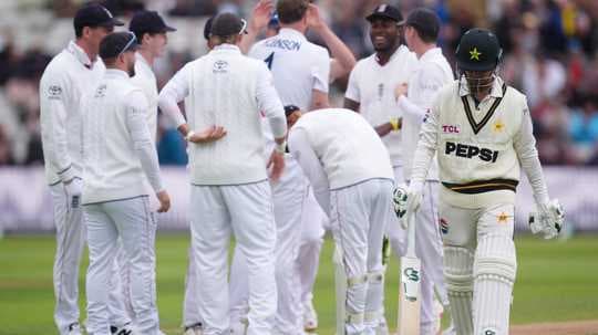 Pakistan player walks past celebrating England team Pakistan player walks past celebrating England team