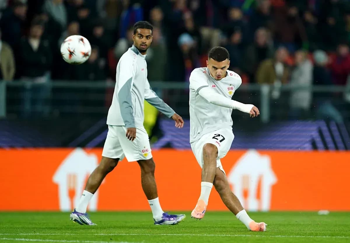 Player kicking a soccer ball during warm-up session Player kicking a soccer ball during warm-up session