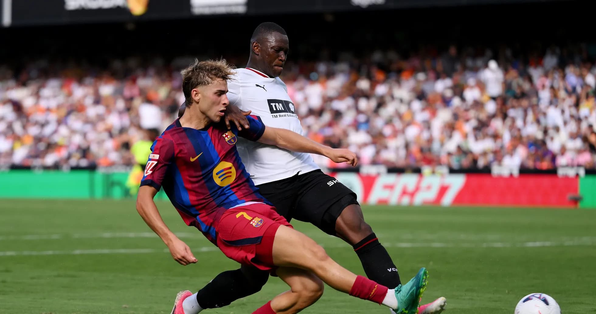 Barcelona player tackled by opponent during match Barcelona player tackled by opponent during match