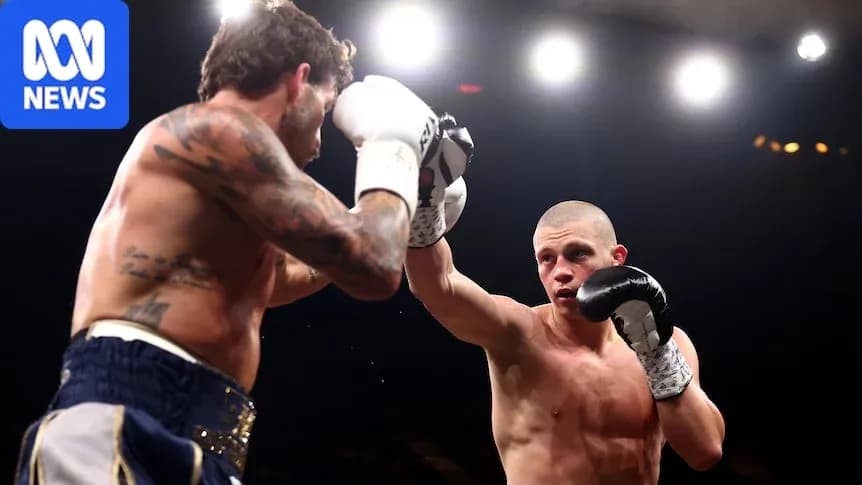 Two boxers exchanging punches in the ring Two boxers exchanging punches in the ring