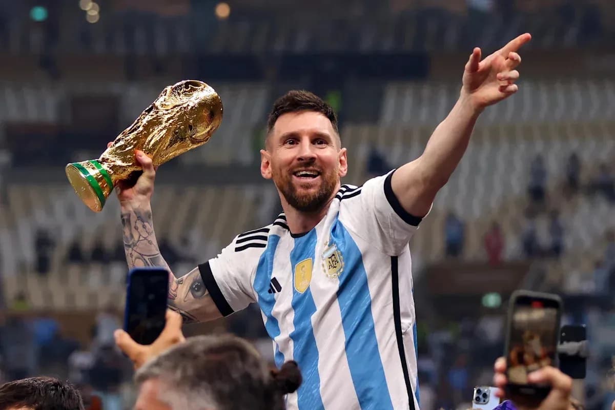 Player celebrating with World Cup trophy in stadium Player celebrating with World Cup trophy in stadium