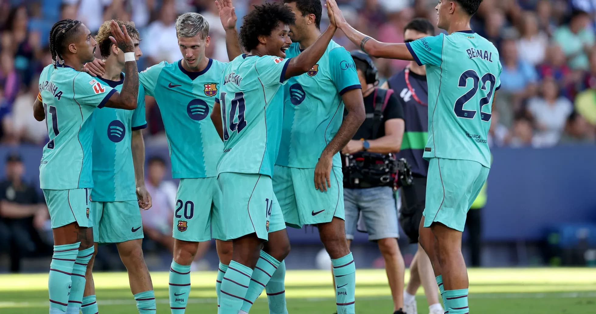 Barcelona players celebrating a goal on the field Barcelona players celebrating a goal on the field