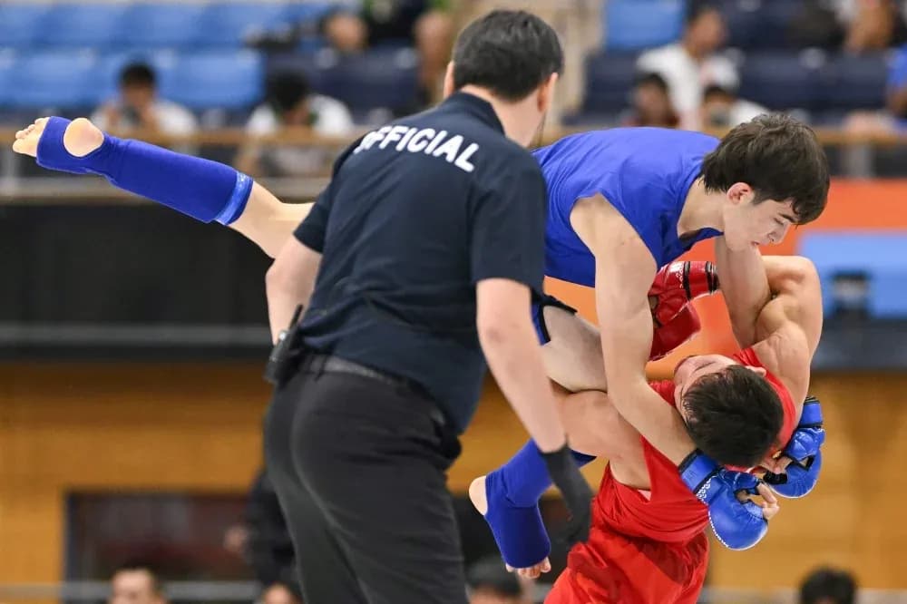 Athletes grappling during a competitive match Athletes grappling during a competitive match