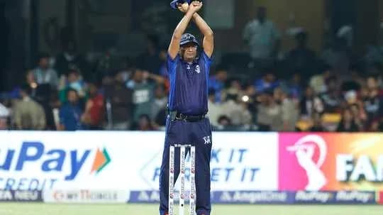 Umpire signaling for a decision during cricket match Umpire signaling for a decision during cricket match