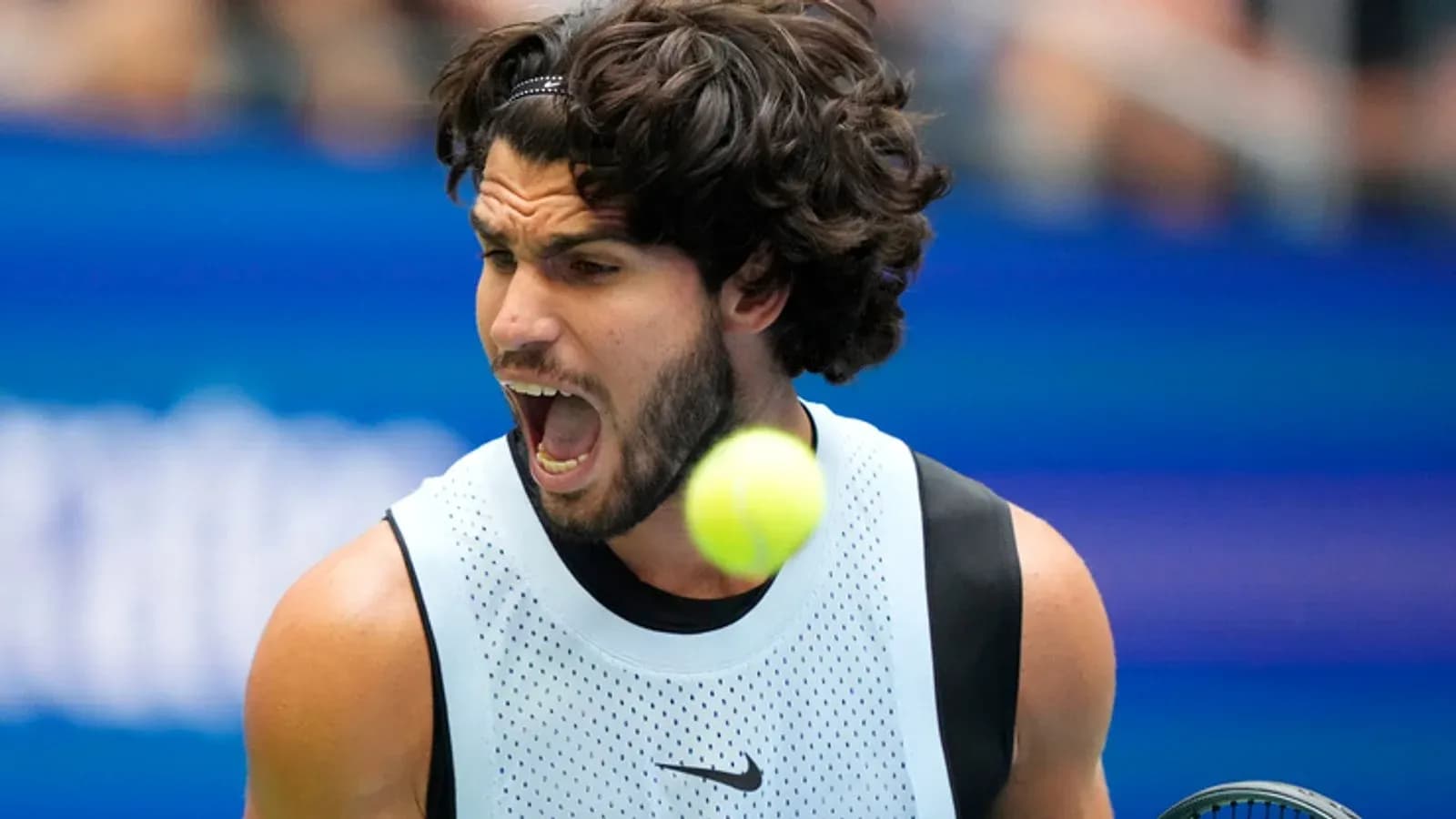 Player shouting while hitting a tennis ball Player shouting while hitting a tennis ball