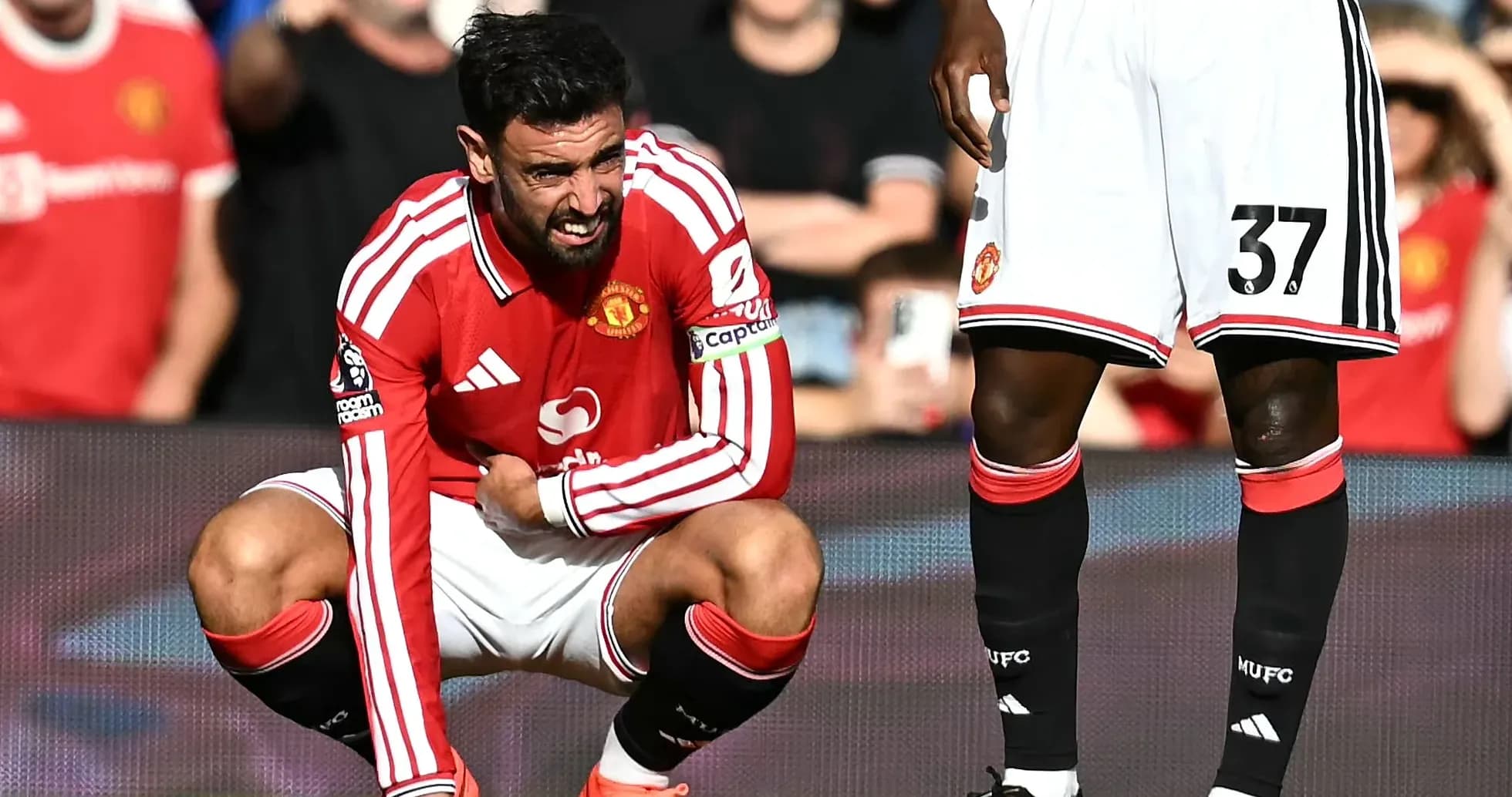 Bruno Fernandes crouching in pain during match Bruno Fernandes crouching in pain during match