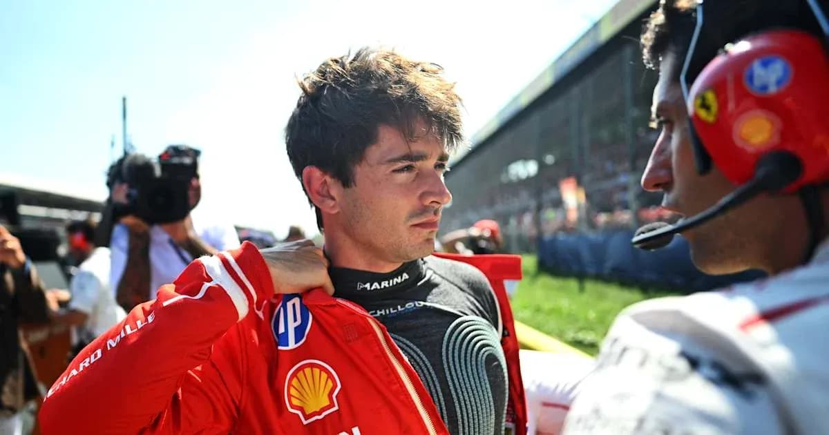 Driver preparing for race with team member nearby Driver preparing for race with team member nearby