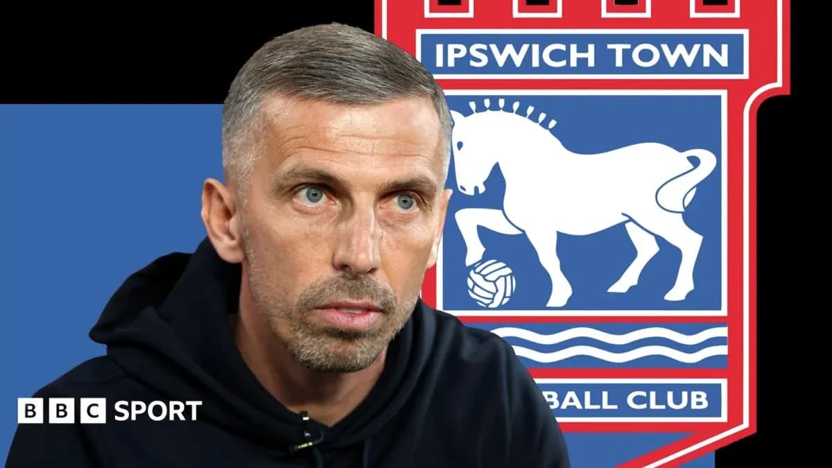 Manager speaking with Ipswich Town logo in background Manager speaking with Ipswich Town logo in background