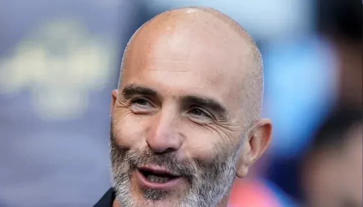 Man smiling during a sports event Man smiling during a sports event
