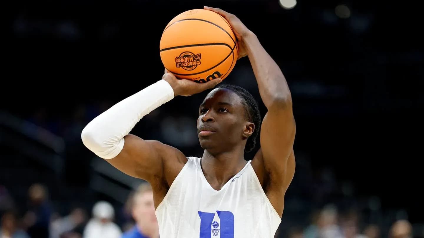 Player preparing to shoot basketball during warm-up Player preparing to shoot basketball during warm-up