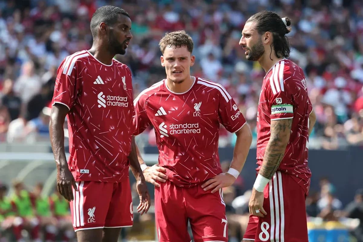 Liverpool players discussing strategy during match Liverpool players discussing strategy during match