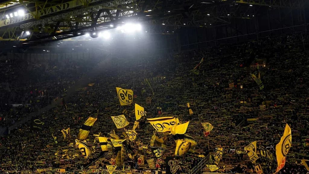 Crowd waving flags at Borussia Dortmund stadium Crowd waving flags at Borussia Dortmund stadium