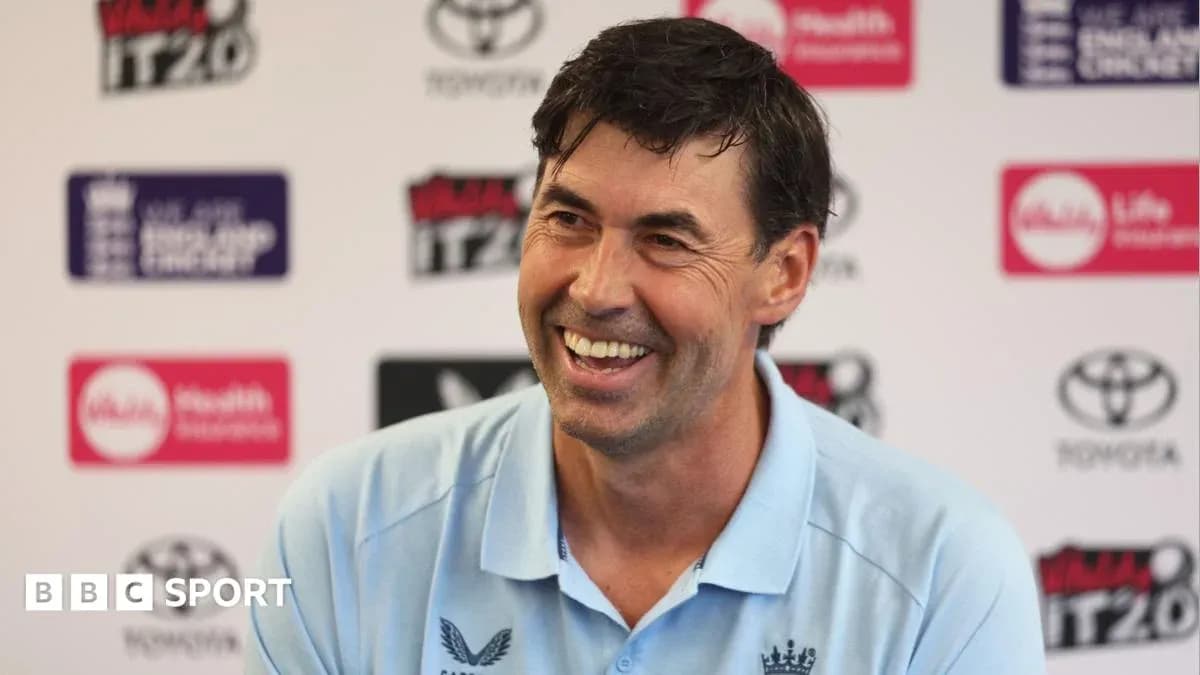 Cricket coach smiling during press conference Cricket coach smiling during press conference