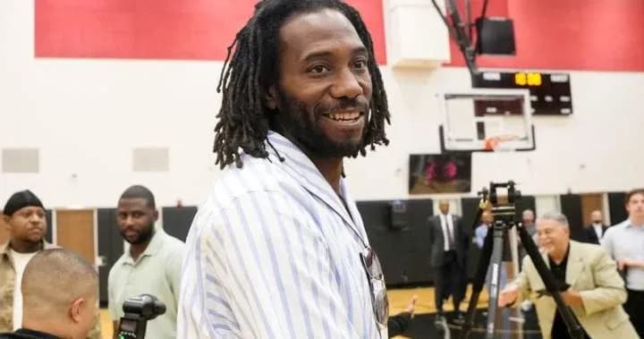 Former player smiling at basketball event Former player smiling at basketball event