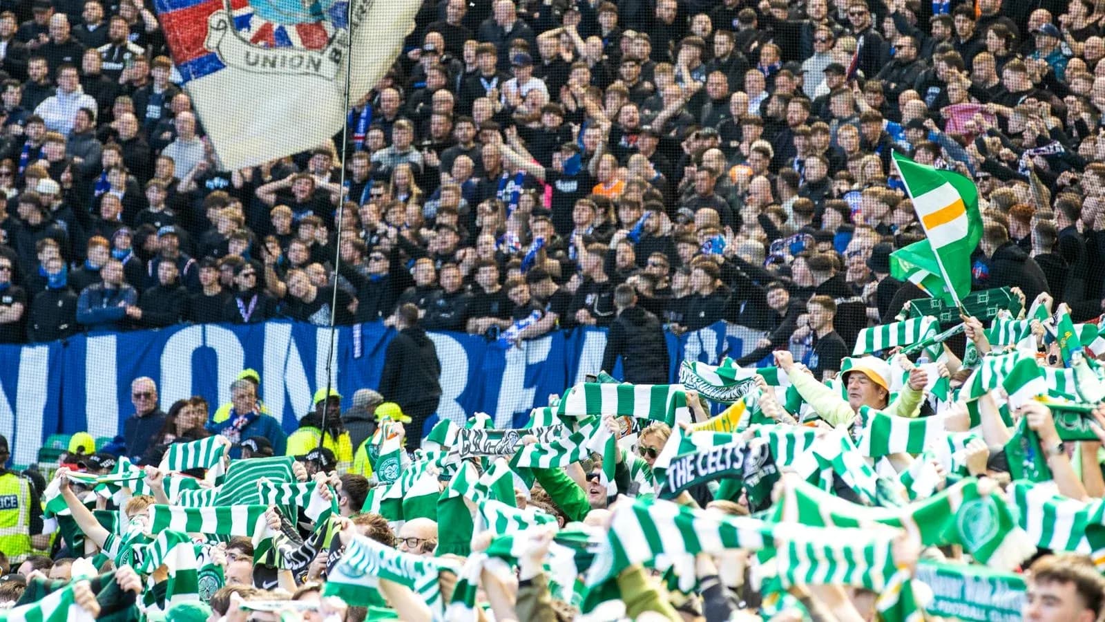 Fans waving green and white scarves in stadium Fans waving green and white scarves in stadium