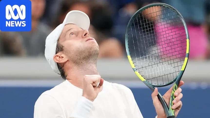 Tennis player celebrating victory with racket raised Tennis player celebrating victory with racket raised